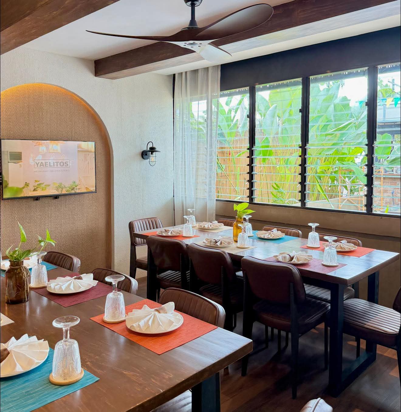 A private Yaelitos dining room prepared with tables and place settings
